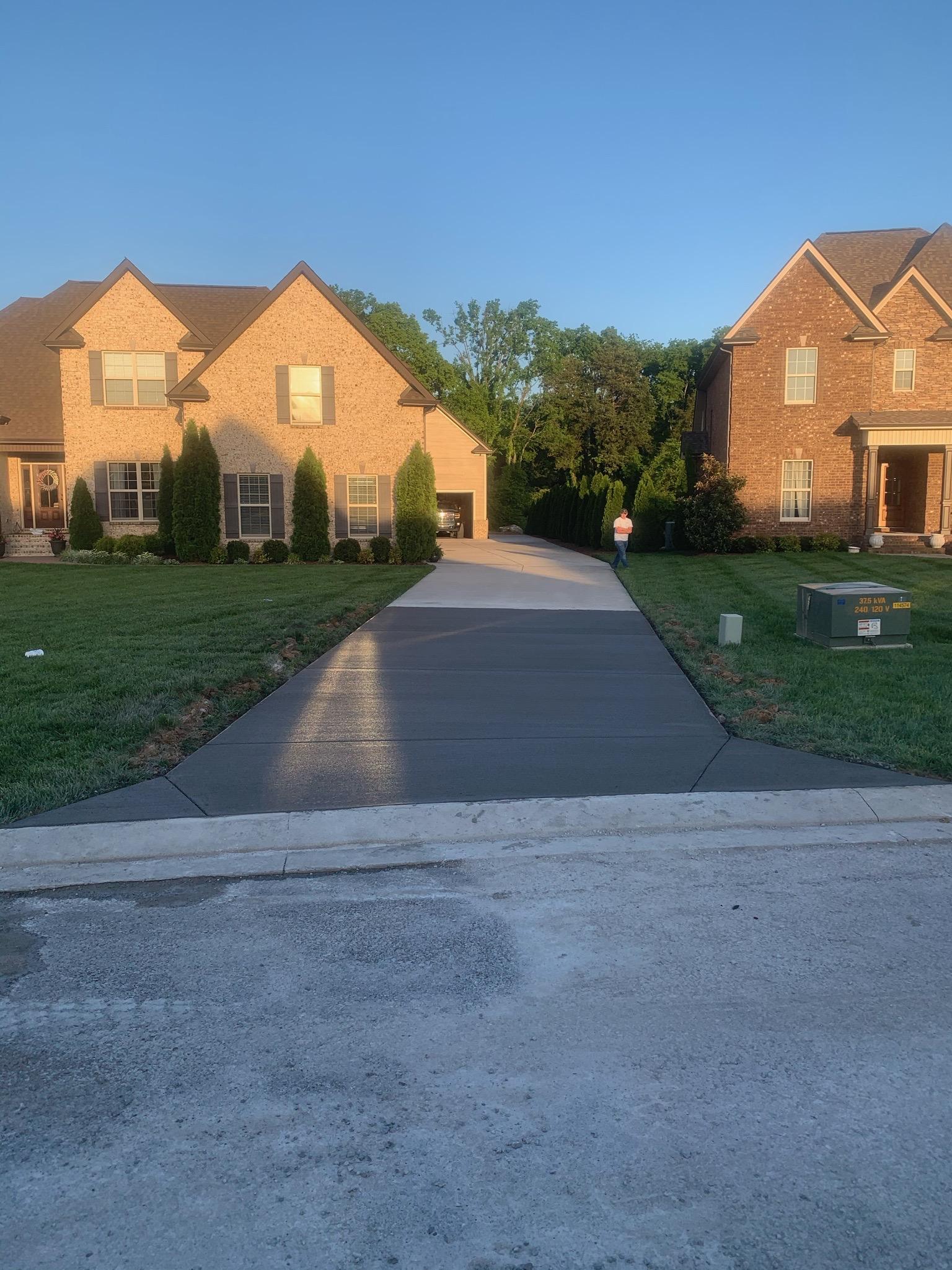 New concrete driveway at a brick home — Complete Concrete TN